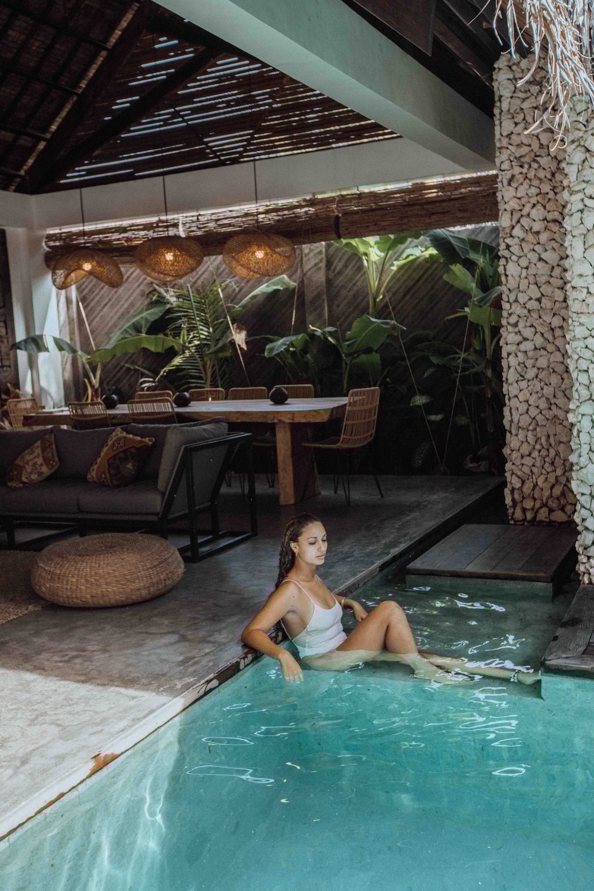 Villa Tulua indoor pool area with tropical dining setup