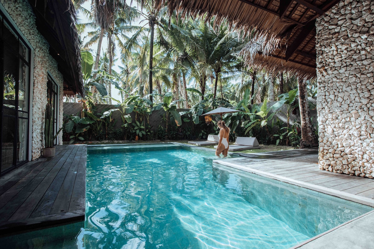 Villa Tulua outdoor pool with palm trees and tropical landscaping