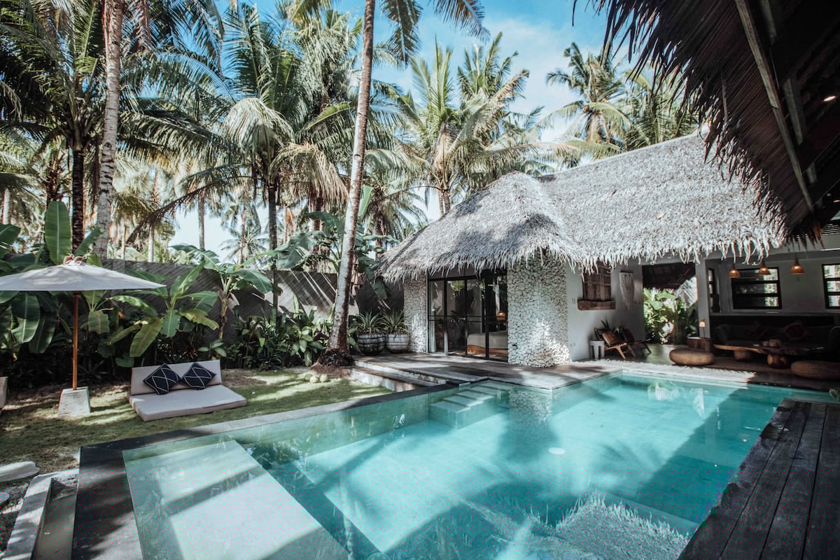 Villa Tulua Villa 2 exterior with infinity pool surrounded by tropical gardens